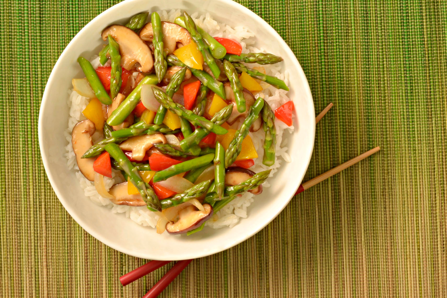 Asparagus-stirfry-with-mushrooms-and-red-pepper-on-white-rice-by-top-Los-Angeles-food-photographer.