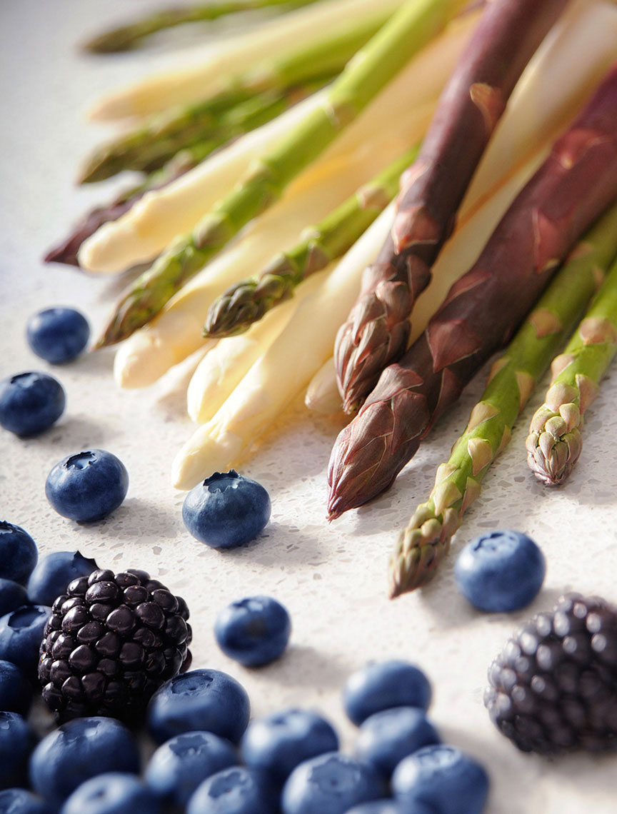 Beautiful-produce-photography-of-blueberries-and-blaclberries-with-green-white-and-purple-asparagus-by-Joe-Atlas-food-photography.