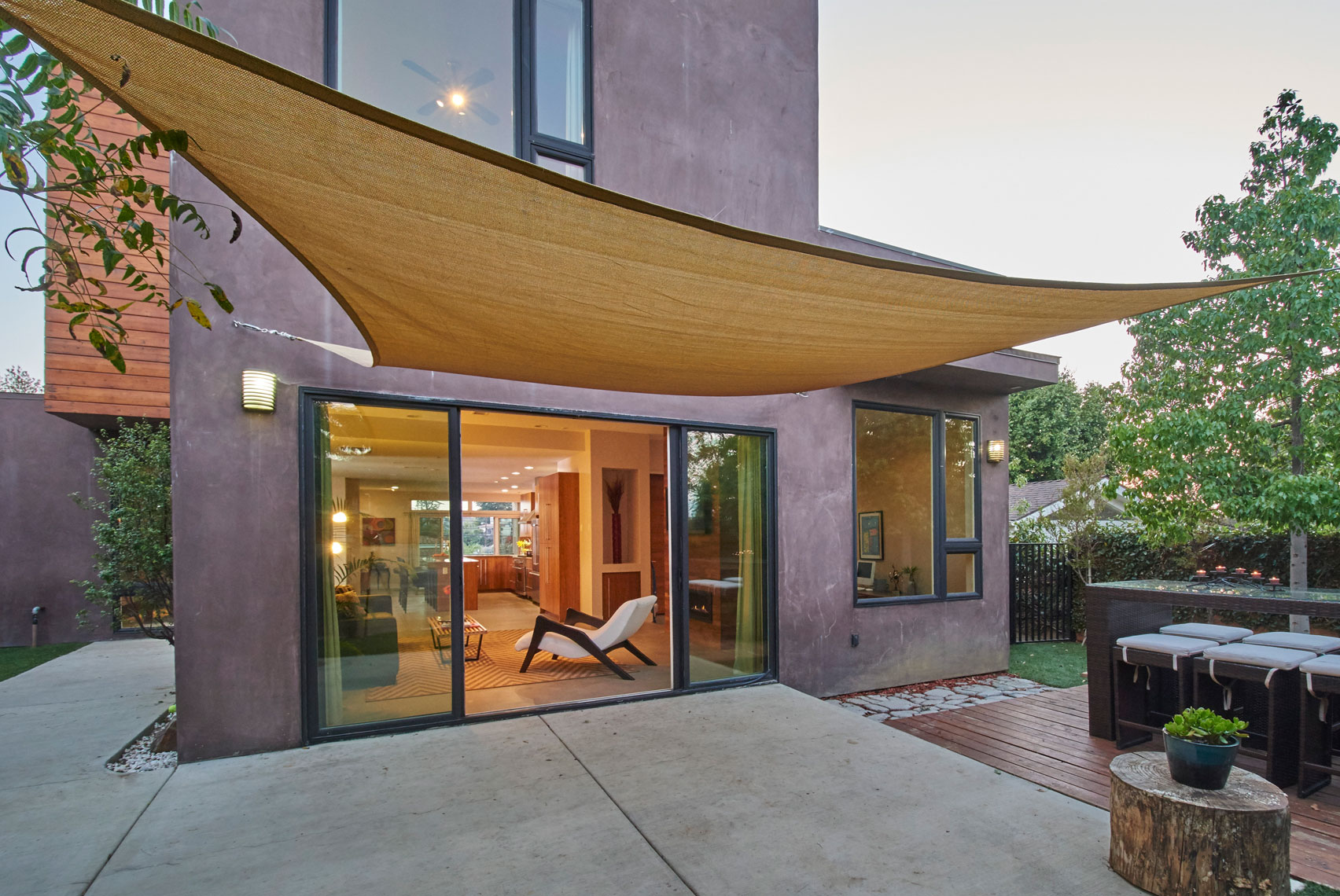Exterior-rear-twilight-view-through-open-sliding-glass-doors-of-Cypress-park-los-angeles-contemporary-hillside-home
