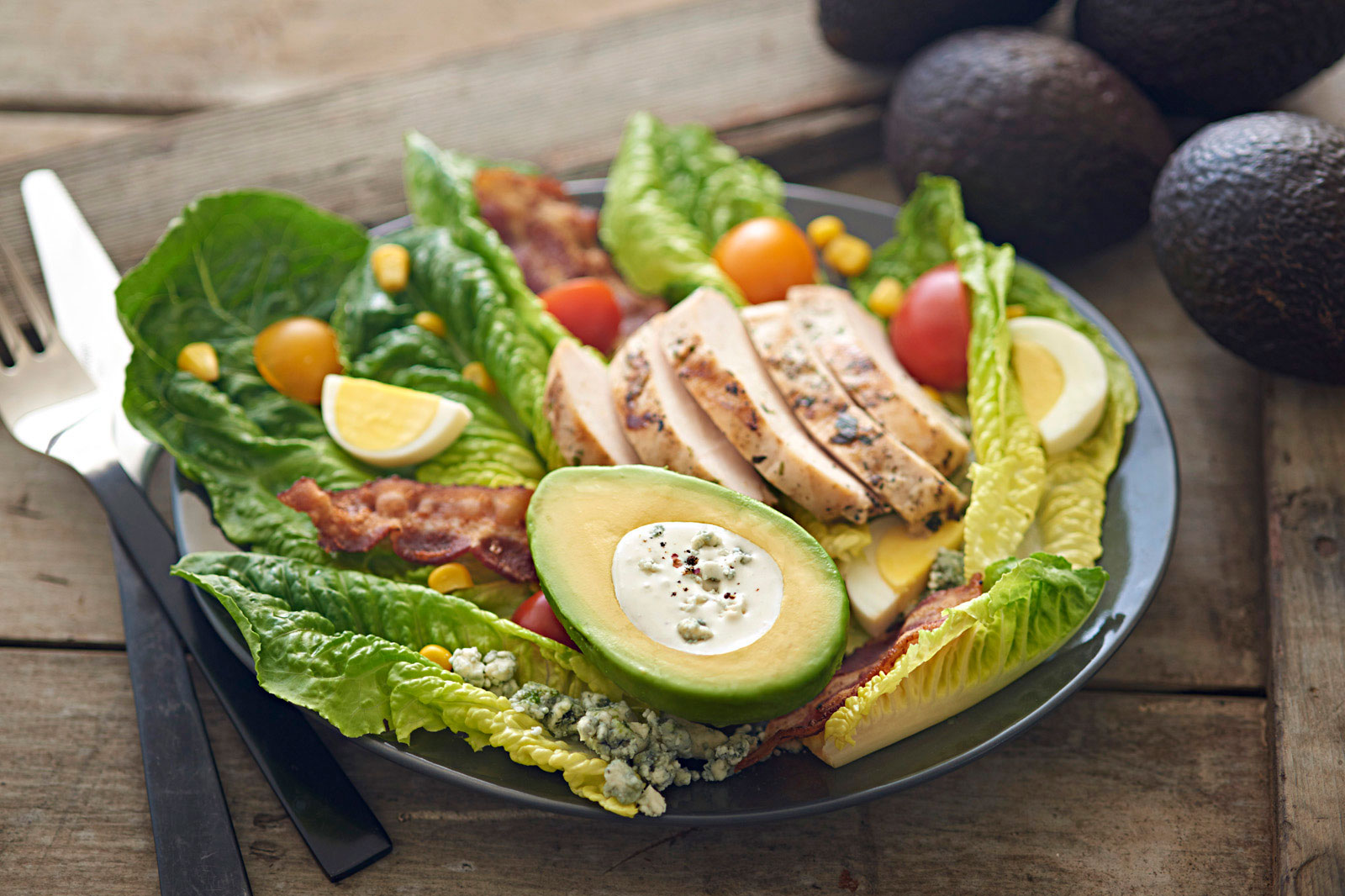 Beautiful-food-photography-of-grilled-chicken-cobb-salad-with-avocado-cup-blue-cheese-dressing