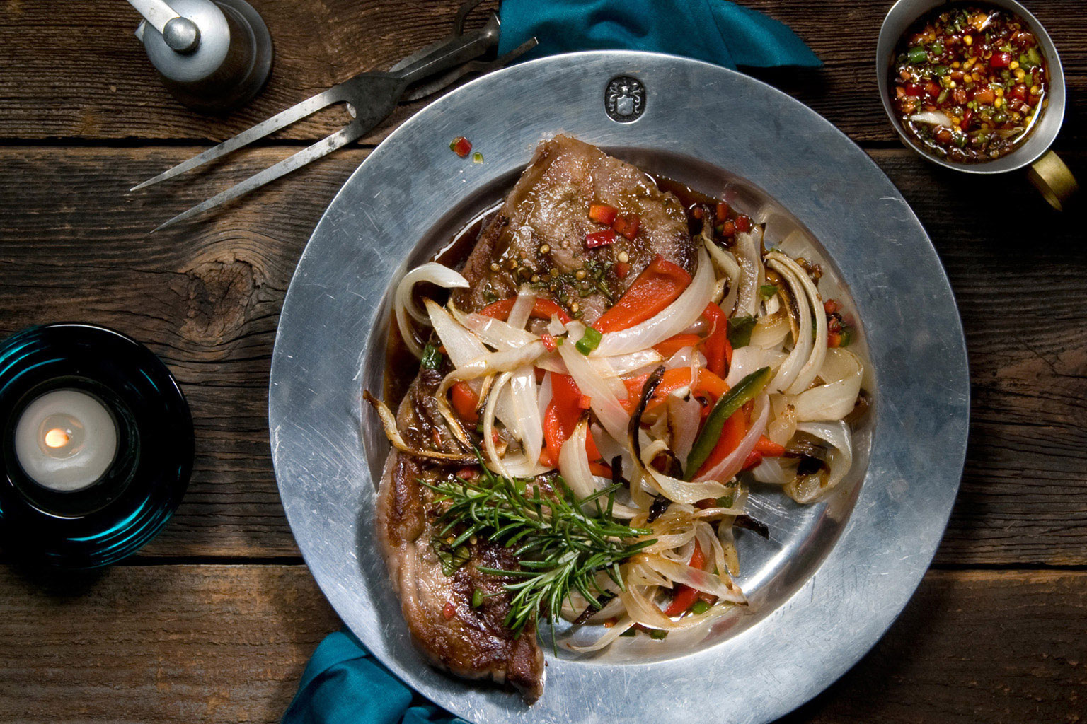 Beautiful-food-photography-of-grilled-rib-eye-steak-with-rosemary-carmelized-onions-and-red-peppers
