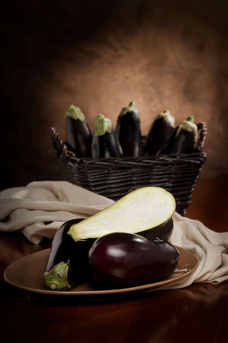Whole-and-cut-eggplants-on-a-plate-and-in-a-basket-by-Joe-Atlas-food-photography.