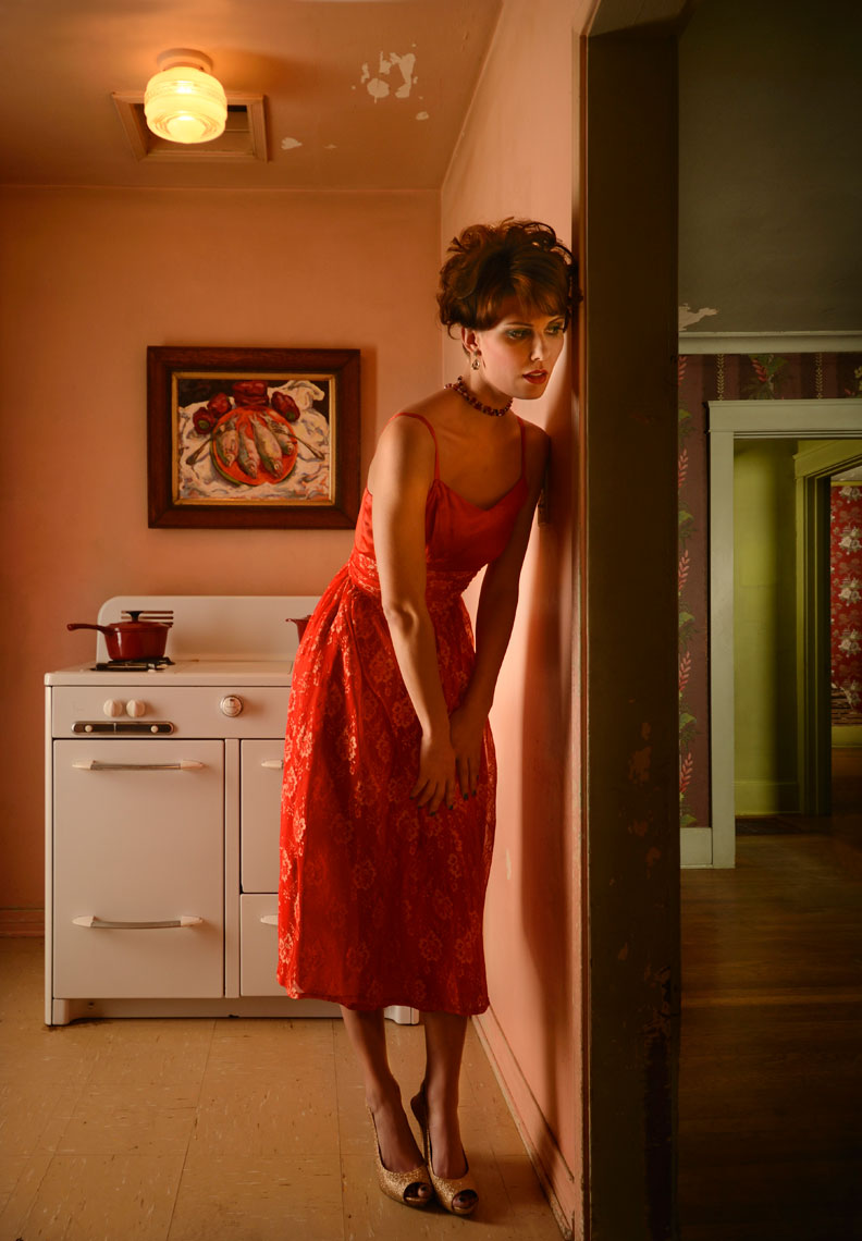 Young-woman-in-kitchen-of-vintage-house-wearing-red-dress-by-lifestyle-photographer-Joe-Atlas.